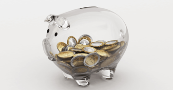 A transparent piggy bank with coins inside