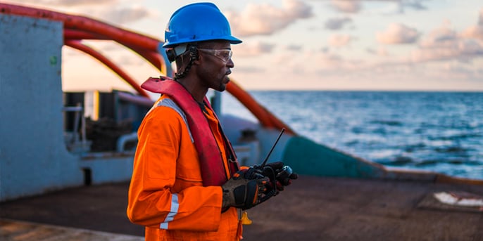 Offshore engineer in safety gear on deck, showcasing engineering recruitment solutions for Rovuma LNG