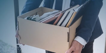 Employee leaving the office with his personal things in a box