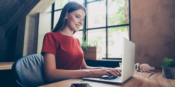 Young jobseeker sitting in workstation, using portable computer device