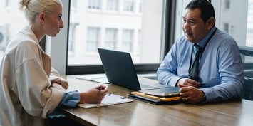 Interviewer and candidate talking in an office